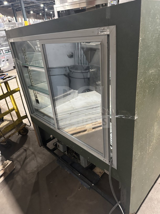 Commercial stainless steel curved glass 3-tier bakery display case with rear double glass sliding door and poly-coated wire rack. Used condition.