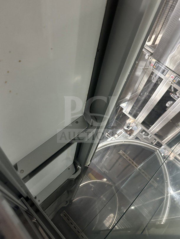 Stainless steel curved glass refrigerated bakery display case, 3-tier, rear sliding doors, poly-coated wire rack.