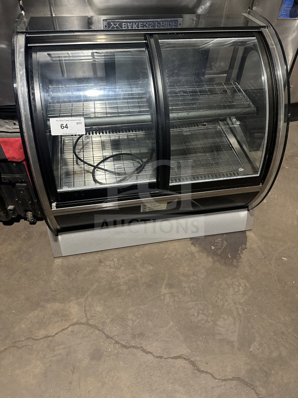 Vollrath RDE8363 countertop refrigerated display case with curved front glass, stainless steel body, dual access doors.