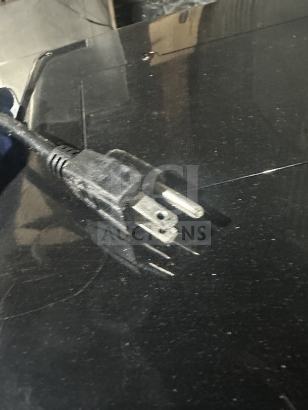 Close-up of the power cord plug for a Berg RT-78L glass door refrigerated merchandiser.