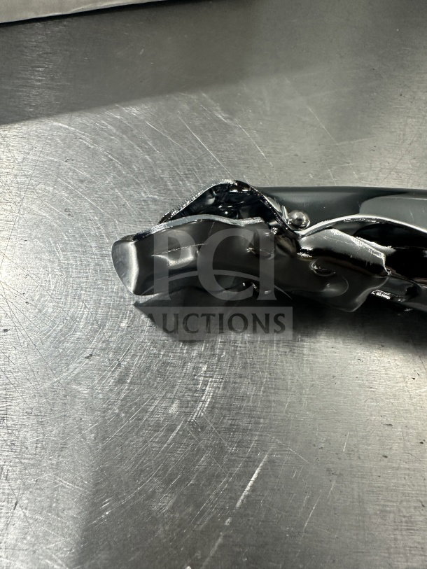 Brand new AmericanMetalCraft stainless steel pan gripper, Model 9525, SN: 704339108405, durable construction.