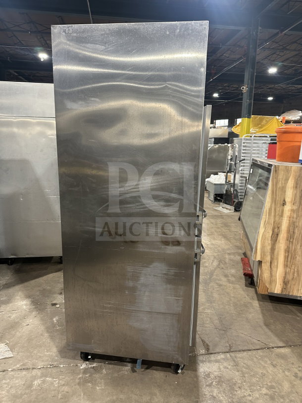 Traulsen stainless steel reach-in refrigerator/freezer combo, model RHT132WUTHHS, on casters, with pan slide and wired rack.