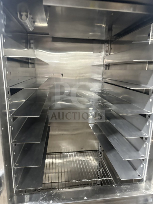 Traulsen stainless steel refrigerator/freezer combo, Model RHT132WUTHHS, with pan slide and chrome rack, on casters.