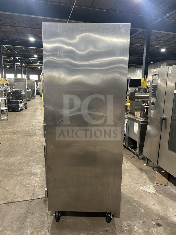 Traulsen RHT132WUTHHS stainless steel refrigerator/freezer combo on casters, shown in warehouse. Includes pan slide and chrome rack.