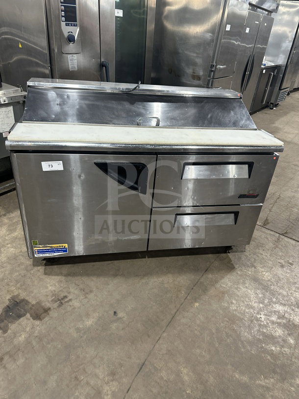 Turbo Air TST60SDD2 stainless steel refrigerated prep table with single solid door, two drawers, and casters.