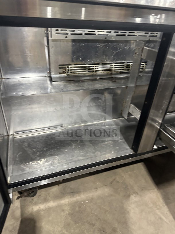 Turbo Air TST60SDD2 stainless steel refrigerated prep table with single solid door, two drawers, and casters.