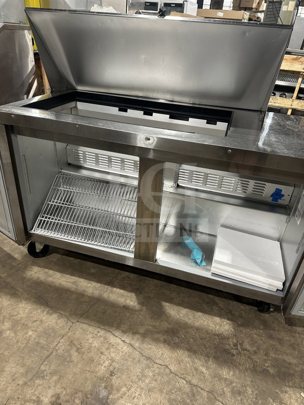 Hoshizaki 2-door refrigerated prep table, model CRMR6018M, stainless steel, on casters, spacious interior, excellent condition.