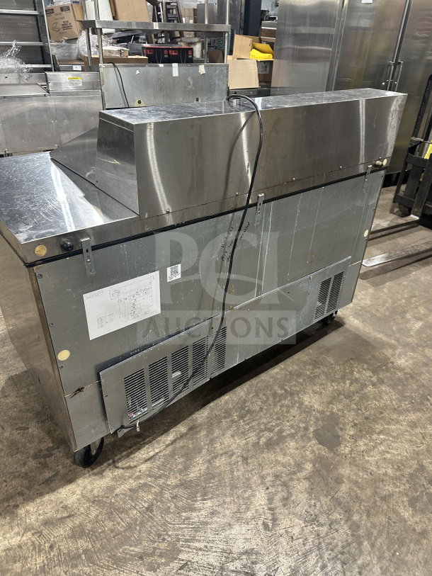 Hoshizaki CRMR6018M stainless steel 2-door refrigerated prep table on casters, showing rear view with ventilation panel and cord.