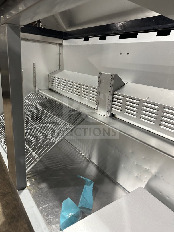 Hoshizaki CRMR6018M stainless steel prep table interior, featuring shelving and vents. Used condition, on casters.