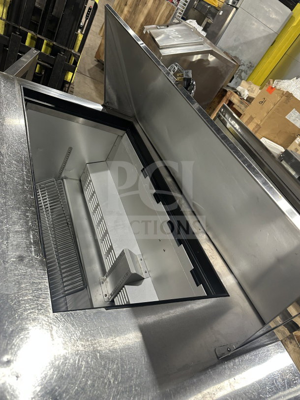Hoshizaki stainless steel 2-door refrigerated prep table, model CRMR6018M, on casters. Open mega top, clean condition.