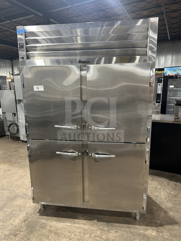 Traulsen SG22300 commercial stainless steel double section reach-in refrigerator/freezer, solid half-doors, poly-coated wired rack, on legs.