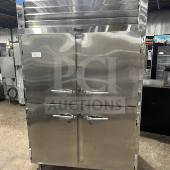Traulsen SG22300 commercial stainless steel double section reach-in refrigerator/freezer, solid half-doors, poly-coated wired rack, on legs.