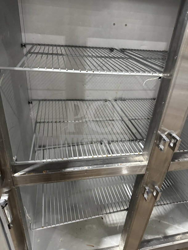 Traulsen SG22300 commercial stainless steel half-door double section reach-in refrigerator/freezer with poly coated wire rack.