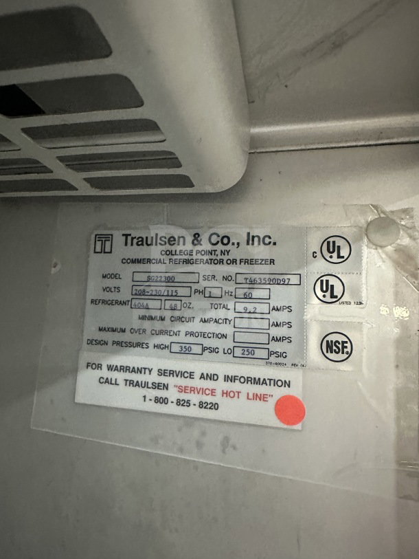 Traulsen SG22300 commercial refrigerator/freezer label, showing model, serial number T463590D97, and voltage specs.