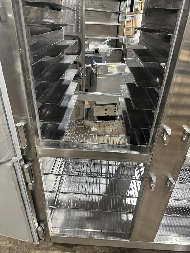 Traulsen stainless steel half-door refrigerator/freezer, model AHT232WUTHHS, with chrome racks and pan slides, on legs.