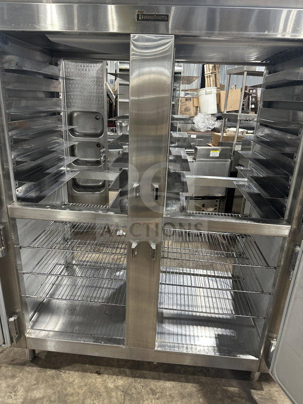 Traulsen stainless steel half-door reach-in refrigerator/freezer, model AHT232WUTHHS, with chrome racks, pan slides, on legs.