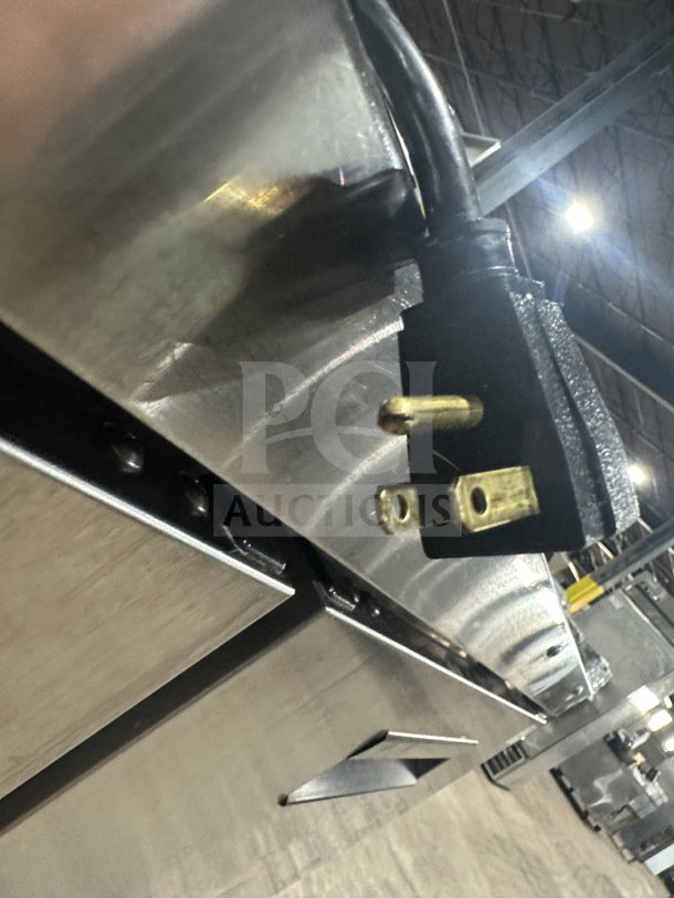 Traulsen stainless steel reach-in refrigerator/freezer, model AHT232WUT-HHS, with rack and pan slides, 115V plug visible.