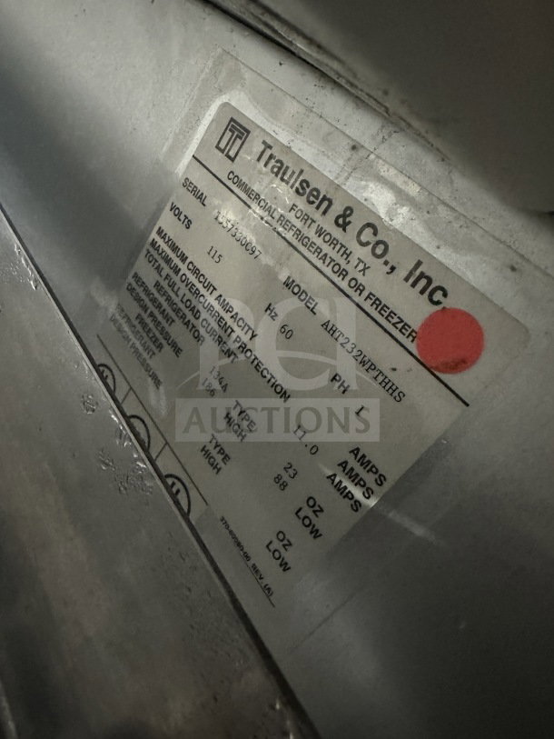 Traulsen commercial stainless steel reach-in refrigerator/freezer, model AHT232WUT-HHS, shown with specifications label.
