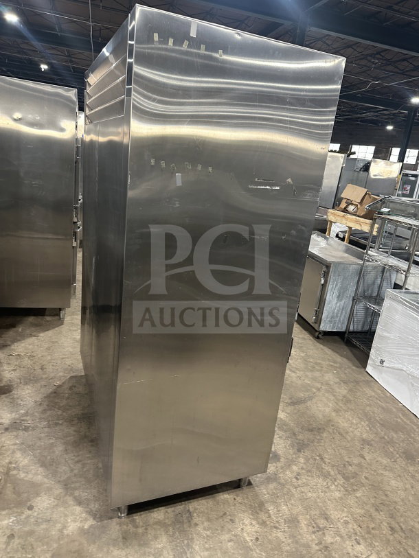 Traulsen stainless steel reach-in refrigerator/freezer, model AHT232WUTHHS, half-door, chrome rack, pan slides, on legs.