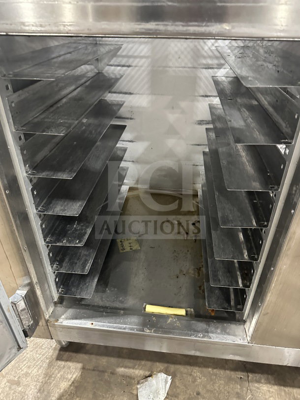 Traulsen AHT232WUTHHS stainless steel half-door reach-in refrigerator/freezer, chrome racks, built-in pan slides, on legs.