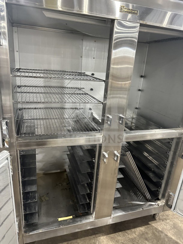 Traulsen stainless steel half-door refrigerator/freezer, model AHT232WUTHHS, with chrome racks and pan slides, on legs.
