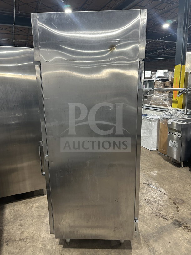 Commercial stainless steel Beverage Air single-door refrigerator with tray/pan slides, on legs, slight wear visible.