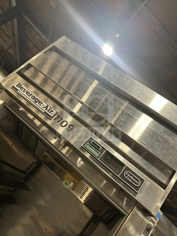 Beverage Air stainless steel single-door reach-in refrigerator with tray slides, on legs. Model number and condition visible.