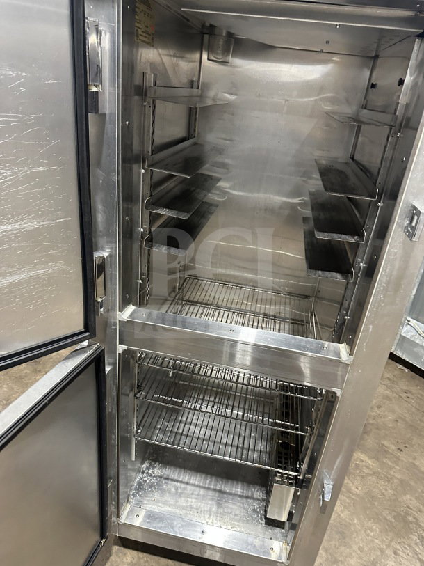 Continental DL1WEHD stainless steel 2-door reach-in refrigerator, Dutch style, with rack and shelf, on casters.