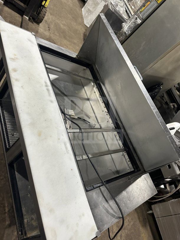 True TSSU-48-18M-B-HC refrigerated prep table, stainless steel, 2-door, poly-coated rack, on casters, good condition.