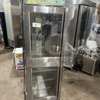 Randell PHHC26 glass half-door reach-in display refrigerator, chrome-plated rack, 115V, 1 phase, on casters, Dairy Connection signage.