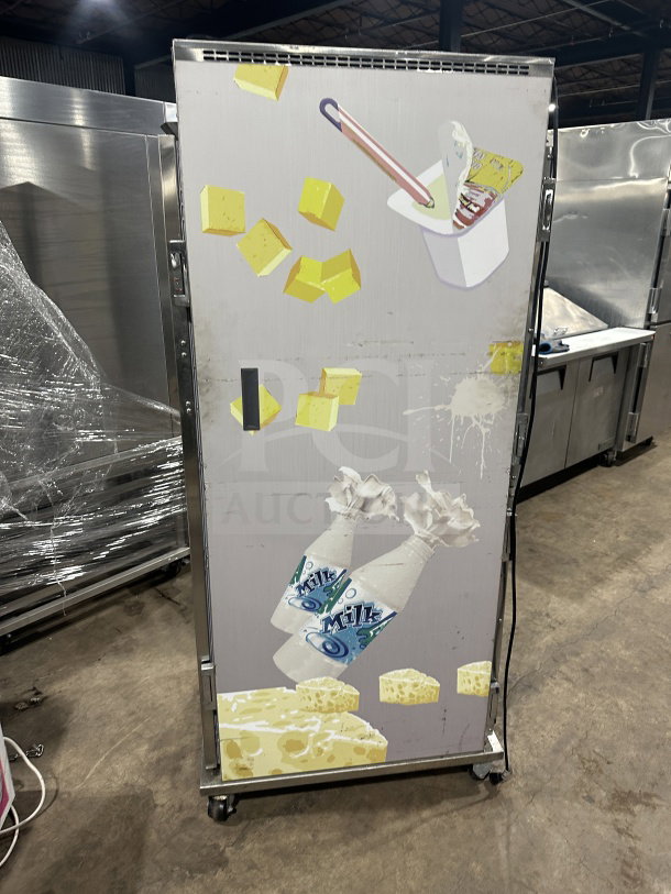 Randell PHHC26 glass half-door display refrigerator with chrome rack, on casters. Model SN: W19332611, 115V, 1 phase, good condition.