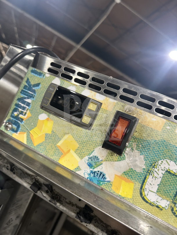 Randell PHHC26 reach-in display refrigerator with temperature control panel and on/off switch, showcasing vibrant graphics.