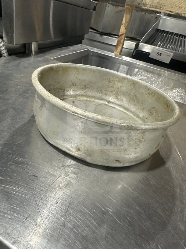 Commercial stainless steel deep-dish pizza pan, used condition, visible wear. Ideal for professional kitchens.