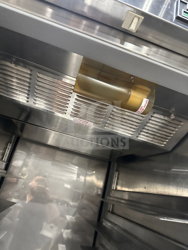 Beverage Air stainless steel single-door refrigerator interior, electric-powered, on legs. Good condition, with caution label.
