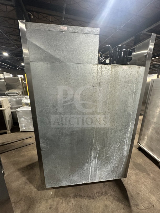 Beverage Air commercial 2-door refrigerator, stainless steel, solid doors, poly-coated wire racks, on legs, industrial setting.