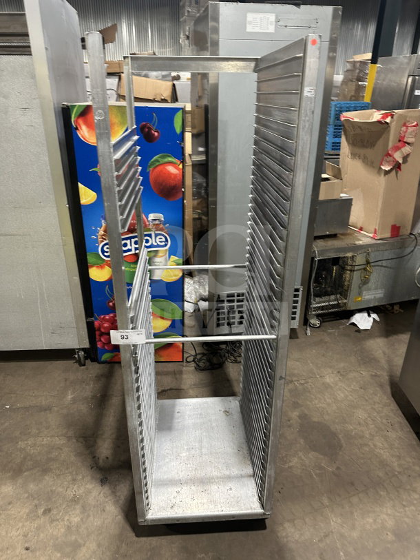Commercial heavy-duty stainless steel bun pan rack on casters, showing multiple welded slots, item label "93" visible.