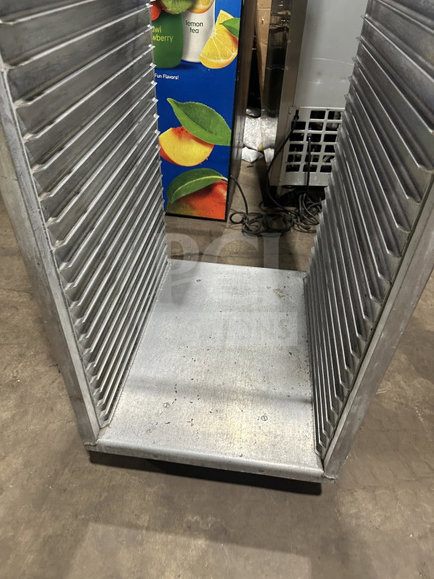 Commercial stainless steel heavy-duty welded pan sheet rack on casters, featuring multiple slots for bun pans.