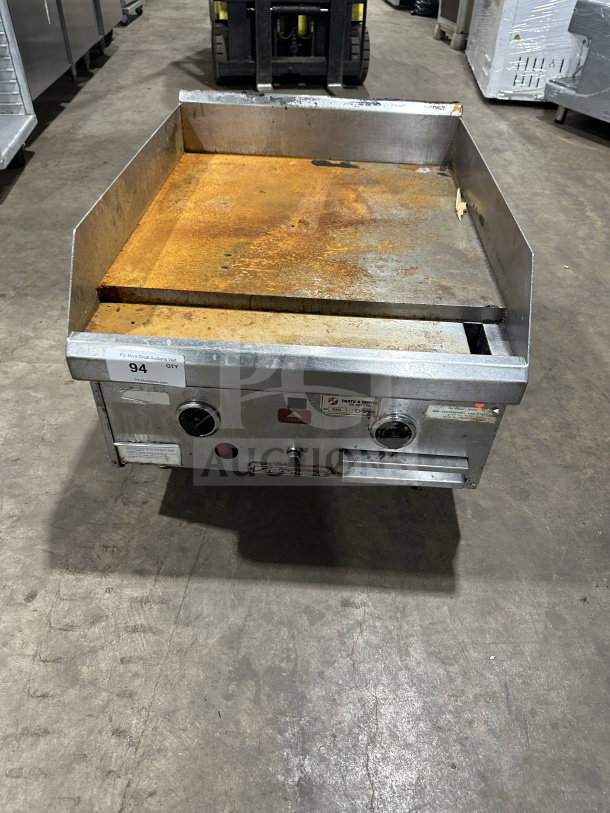 Southbend commercial stainless steel natural gas countertop flat griddle with back and side splash, on legs, showing some rust.