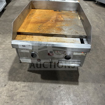 Southbend commercial stainless steel natural gas countertop flat griddle with back and side splash, on legs, showing some rust.