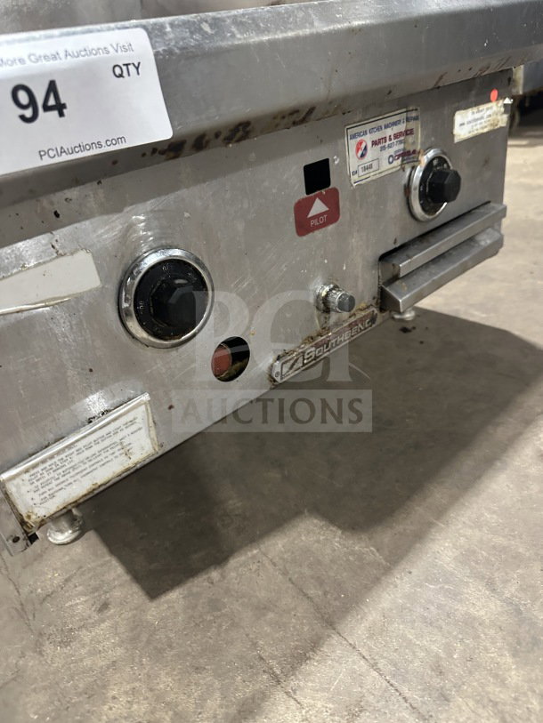 Southbend stainless steel natural gas countertop flat griddle with back and side splash, used condition, includes control knobs and pilot light indicator.