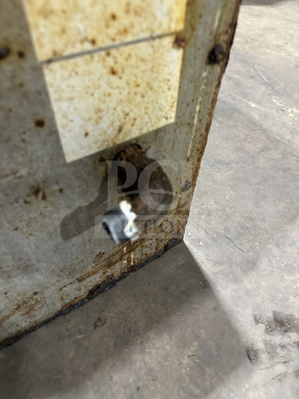 Rusted part of American Range stainless steel griddle showing gas inlet connection, indicating wear.