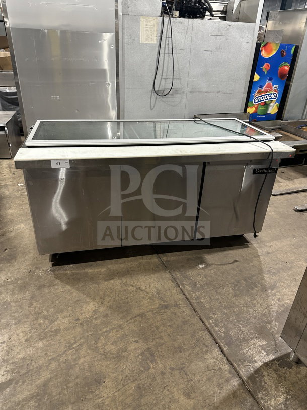 Continental 3-Door Stainless Steel Refrigerated Prep Table, Model SW72-30M, with glass lid and casters, in used condition.