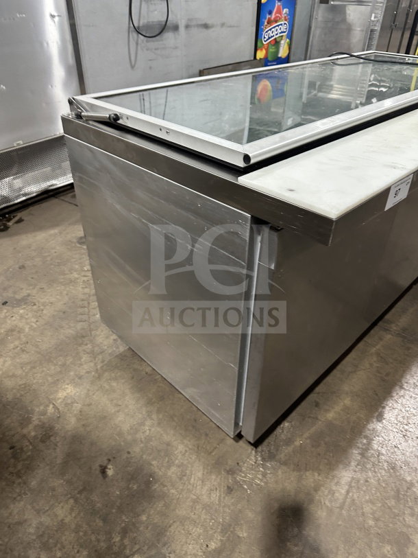 Continental stainless steel 3-door refrigerated prep table, Model SW72-30M, with glass lid and casters, in used condition.