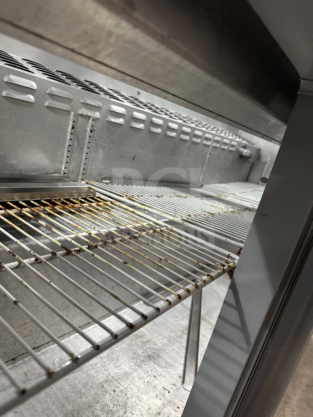Continental 3-Door Refrigerated Prep Table, model SW72-30M, interior view showing metal shelving and see-thru glass lid.