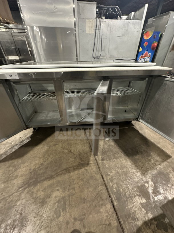 Continental SW72-30M stainless steel 3-door refrigerated prep table with glass cover, on casters. Serial number 15580567.