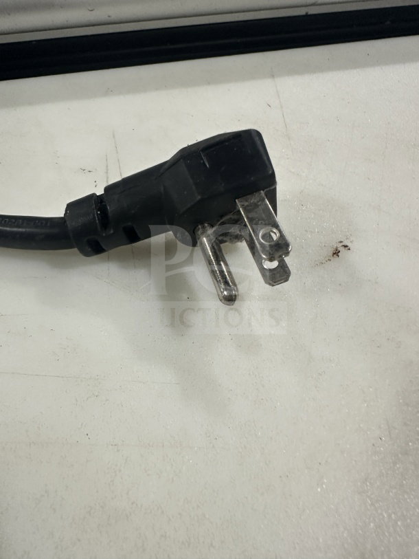 Close-up image of a black power plug for the Continental Refrigerated Mega Top Prep Table, showing a three-prong design.