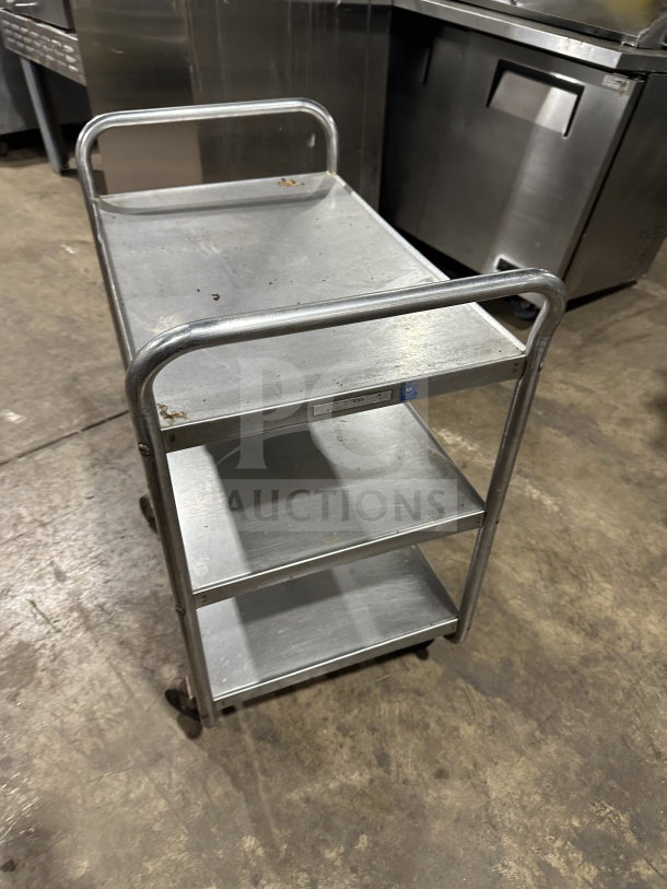 Commercial stainless steel 3-shelf utility cart with legs, good condition, sturdy construction, visible minor wear.