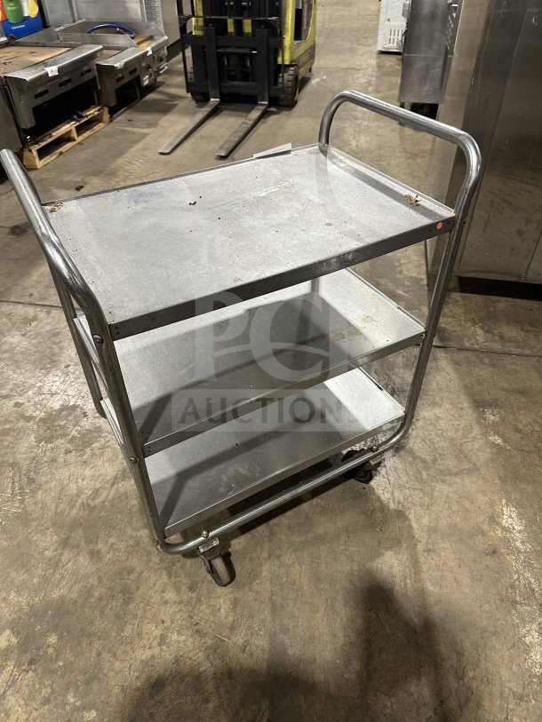 Commercial stainless steel 3-shelf utility cart on wheels. Used condition, sturdy metal frame, spacious shelves.