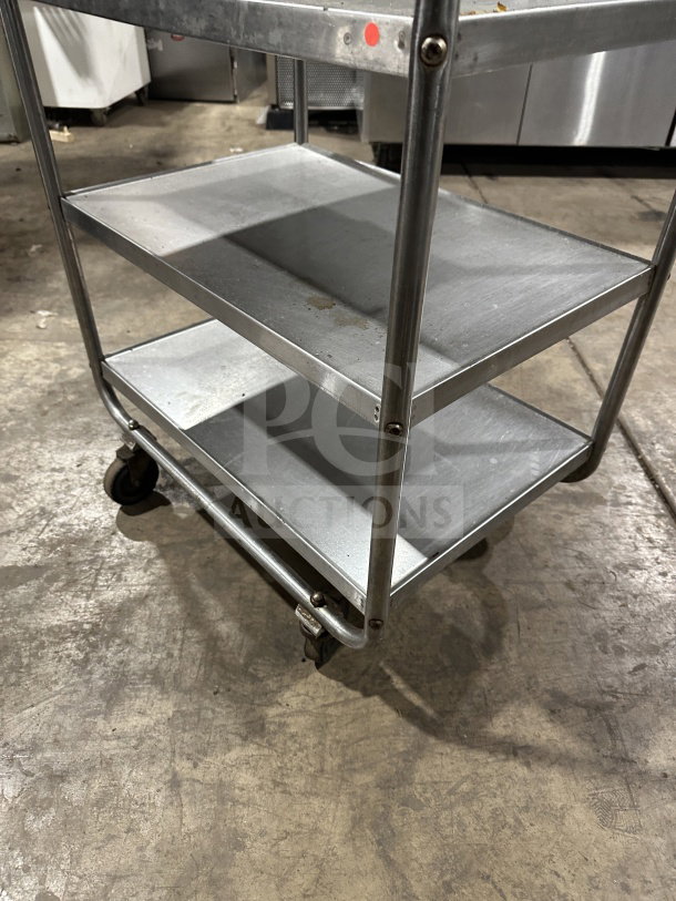 Commercial stainless steel 3-shelf utility cart with wheels, good condition, durable, ideal for kitchen or warehouse use.