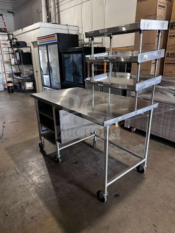 Stainless steel commercial work table with multi-tier overshelf, approx. 60"x36", mobile, inspected, ready for use.